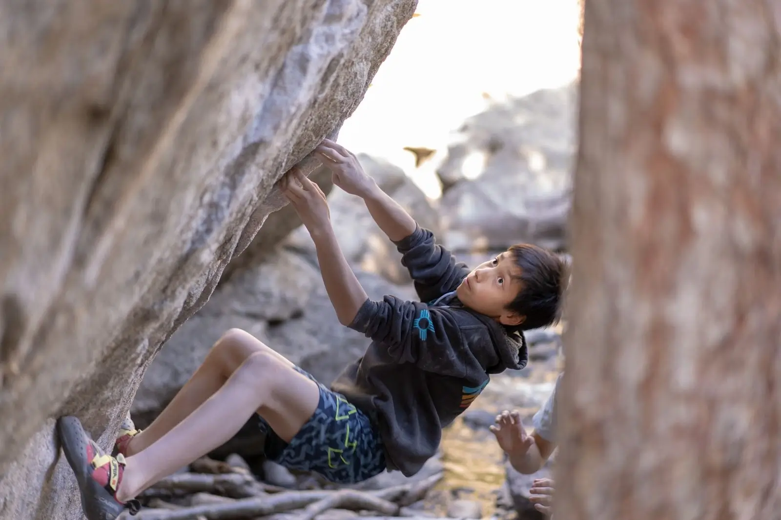 Thai boy rock climbing on Koh Tao